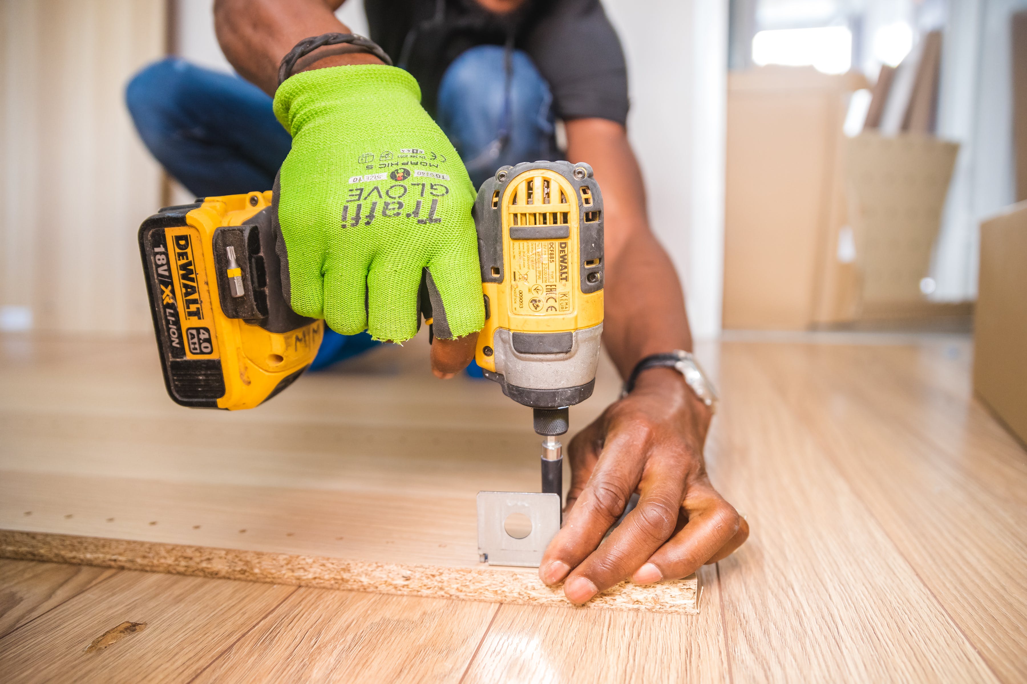 carpenter drilling on door hinges